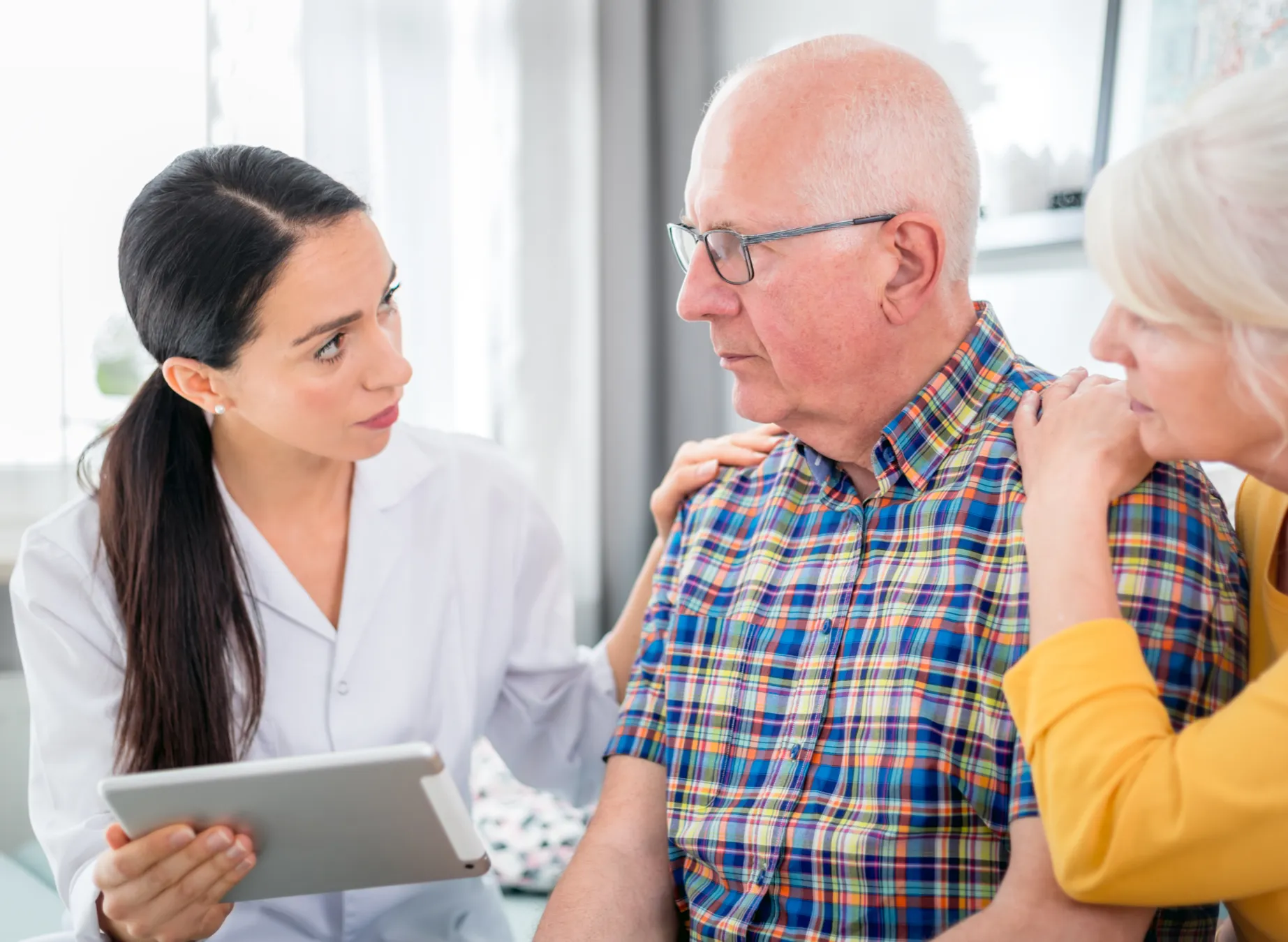 Healthcare Provider Talking to Older Man and Woman